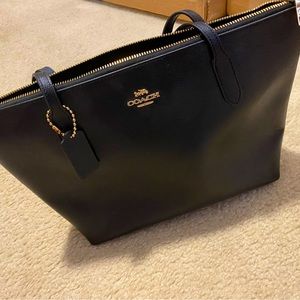 Black coach bag with gold detail